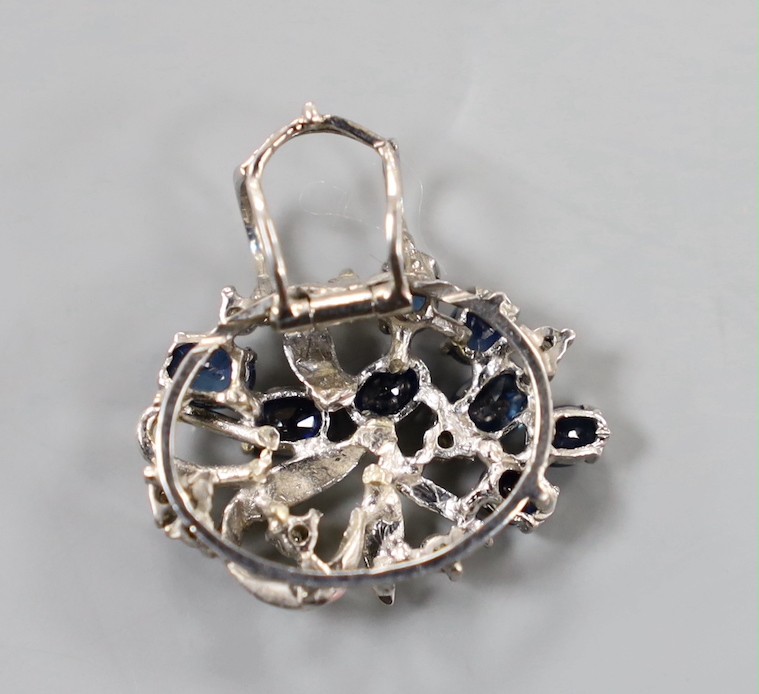 A yellow and white metal, sapphire and diamond cluster set oval pendant, 20mm, gross weight 3.8 grams.